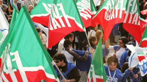 Militants hold Forza Italia's flag befor