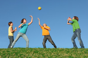 Active kids playing ball at summer camp